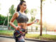Athletic girl jogging with headphones in park